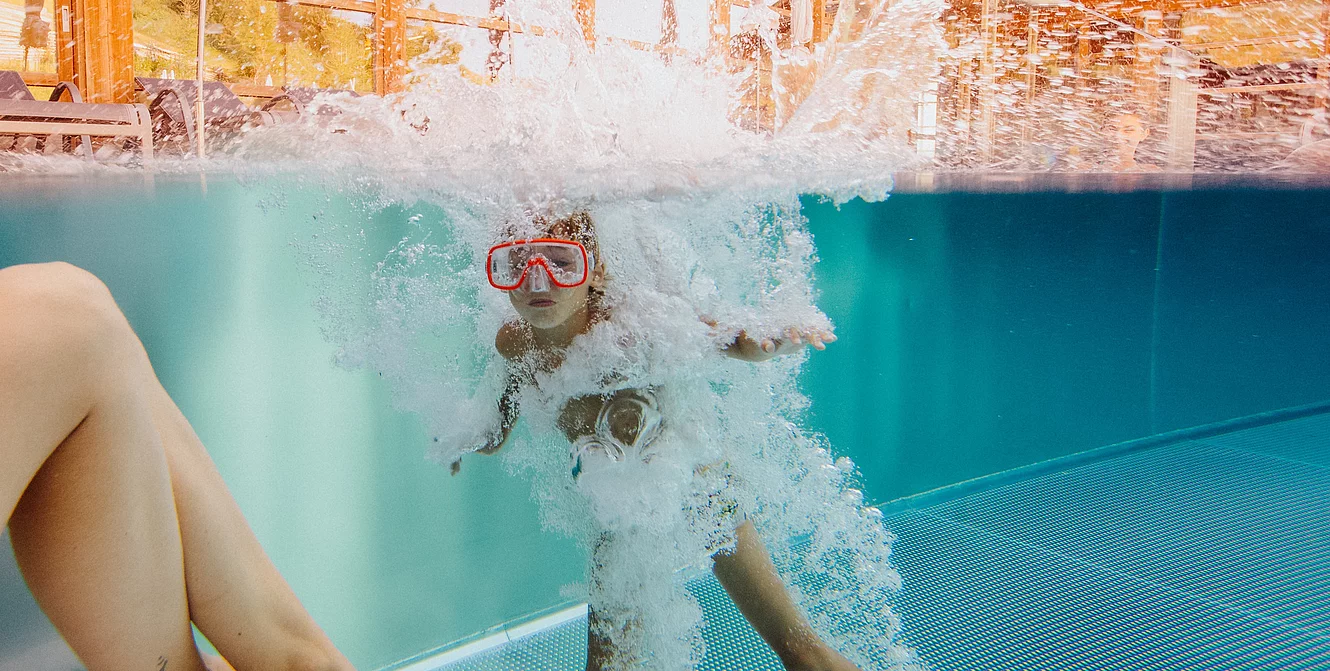 Boy is swimming in a pool