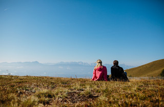 Mann und Frau beim Rasten nach einer Wanderung im Urlaub nahe des Mountain Resort Feuerberg in Kärnten